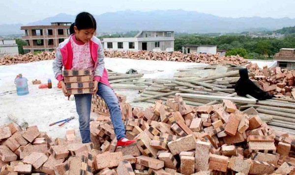 女孩工地上垒砖当"书桌" 陪父母干活